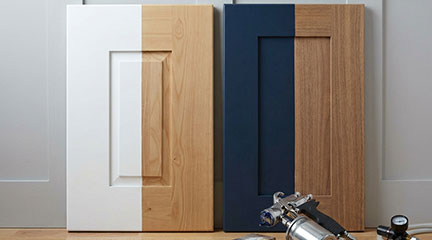 Split view of oak kitchen cabinet doors showing the professional resurfacing process from raw wood to a flawless factory-grade 2K navy and white finish with professional spray equipment.