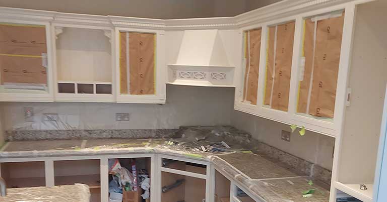 Kitchen Cabinets Prepped For Respray With Masking Tape